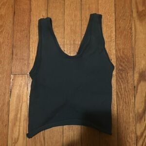 Cropped green tank top with open crossed back.